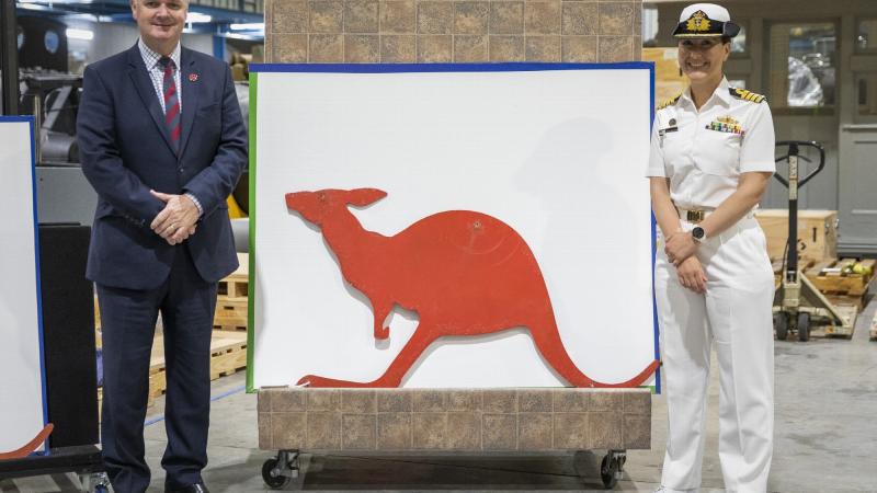 (Australian War Memorial Director Mr Matt Anderson and Captain Anita Nemarich, RAN, with one of the donated red kangaroo funnel insignia from HMAS Parramatta at the Treloar Technology Centre, ACT. Photo: Leading Seaman Kylie Jagiello