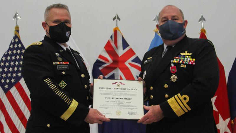General Paul LaCamera presents Vice Admiral Stuart Mayer with the Legion of Merit Degree of Officer during the farewell ceremony at Camp Humphreys. Photo: Staff Sergeant Kris Bonet