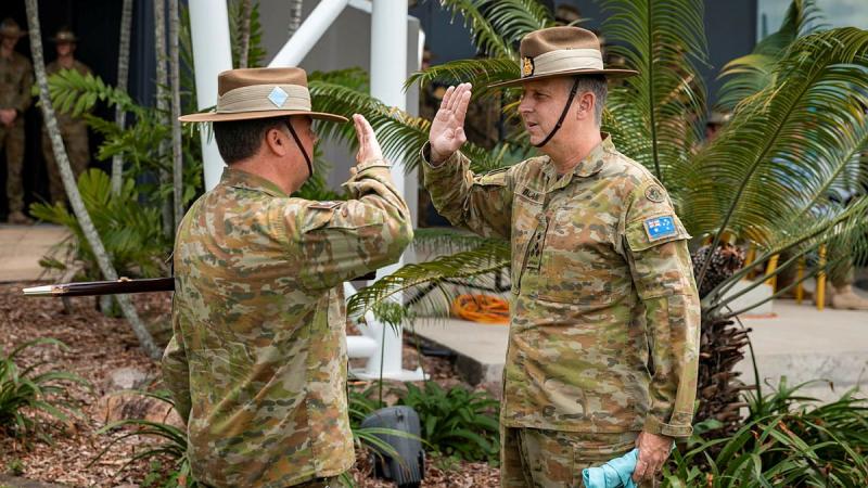 Outgoing Commander of the 7th Brigade, Brigadier Jason Blain, right, receives the brigade pennant from Regimental Sergeant Major Warrant Officer Class One Matthew Bold at Gallipoli Barracks, Brisbane. Photo: Corporal Nicole Dorrett