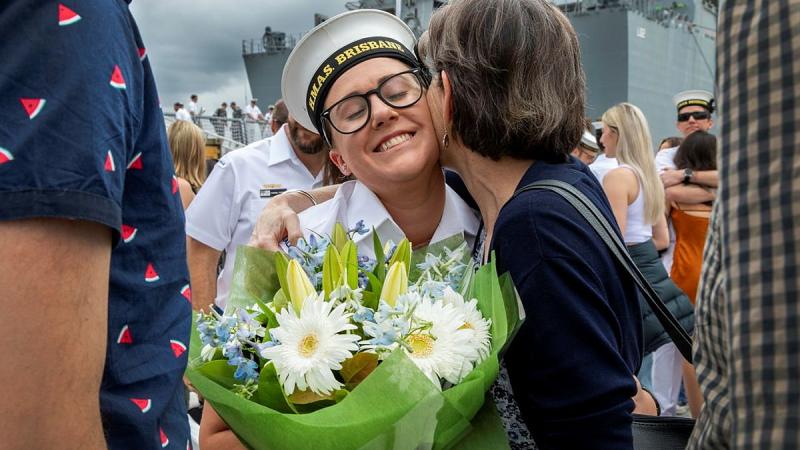 Seaman Cloe Reichelt is welcomed by her mother at Fleet Base East, Sydney, after HMAS Brisbane returned to her home port at the end of a three-month deployment. Photo: Able Seaman Susan Mossop