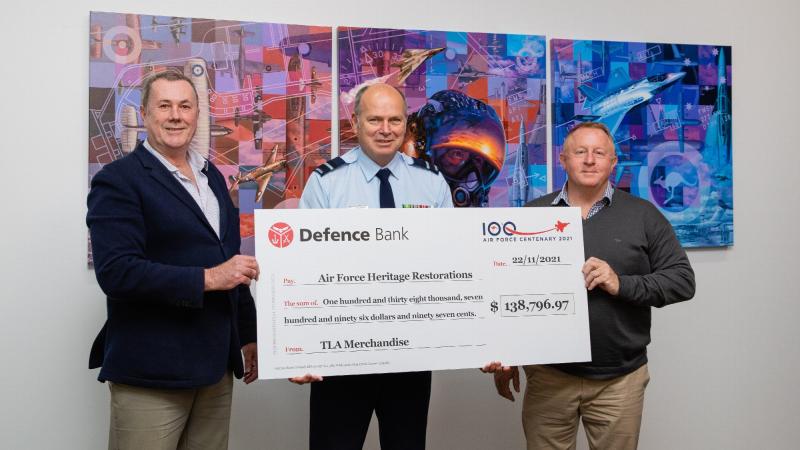 CEO of The Air Force Shop Stephen Davie, left, Director General Air Force 2021 Air Commodore Andrew Elfverson and General Manager TLA Merchandise Terry Wilson at the presentation of funds raised through Air Force centenary merchandise sales.