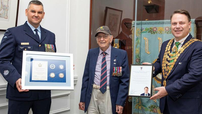Warrant Officer Michael McDonnell, left, and Lord Mayor of Brisbane Councillor Adrian Schrinner, right with WWII veteran and centenarian Esdale Davis. Photo: Corporal Jesse Kane