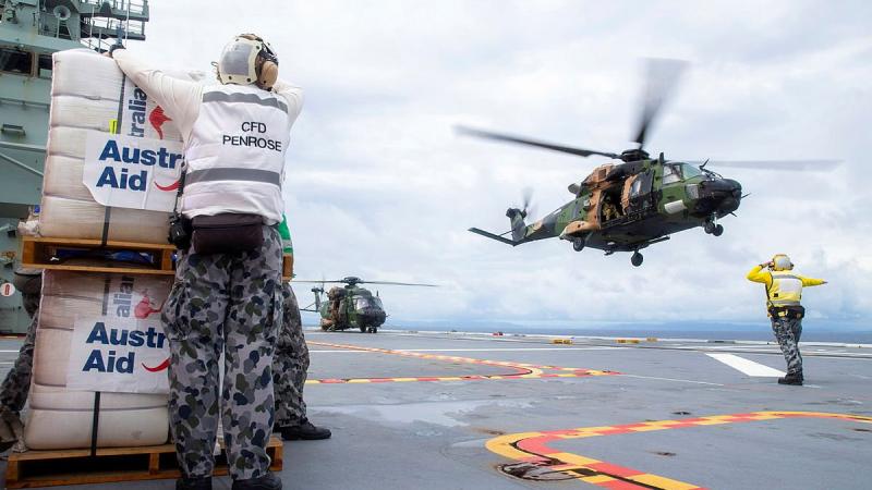 A MRH-90 Taipan launches from the flight deck of HMAS Adelaide to drop disaster relief supplies to Nabouwalu on the island of Vanua Levu, Fiji, during Operation Fiji Assist. Photo: Corporal Dustin Anderson