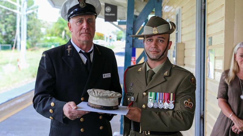 Former Navy paramedic Jamie Hodgess, left, and his nephew Army petroleum operator Warrant Officer Class Two Stuart Hodgess with the Navy hat that belonged to Jamie Hodgess' father, Gus. Photo: Lance Corporal Christopher Smith