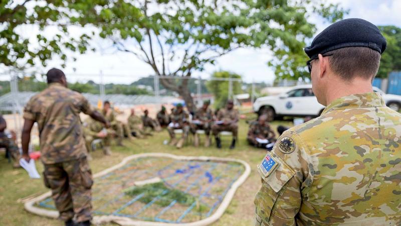 Australian Army Warrant Officer Class Two Angus O'Neill watches a Vanuatu Police Force officer give orders during the sergeants' course run by the Australian Army Mobile Training Team in Port Vila, Vanuatu. Photo: Corporal Robert Whitmore