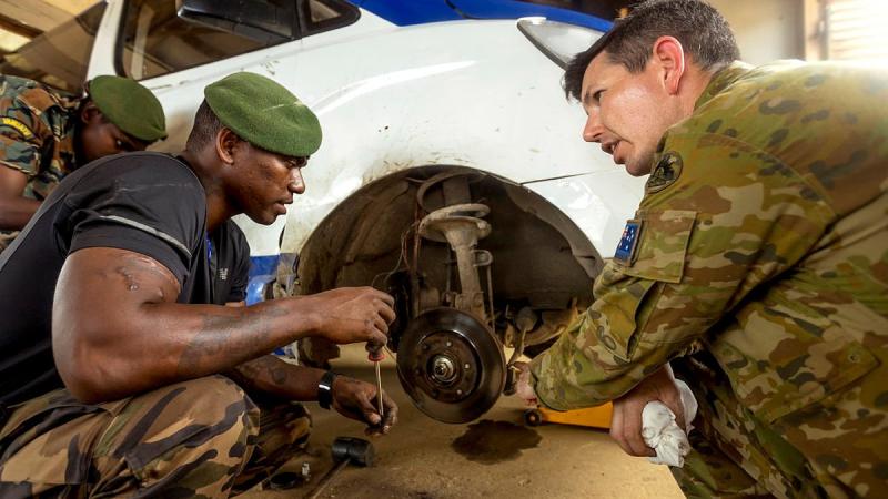 Australian Army Sergeant Dale Daff and Vanuatu Police Force Private John Pierre work on a vehicle during the vehicle maintainers' course at Cook Barracks in Port Vila, Vanuatu. Photo: Corporal Robert Whitmore