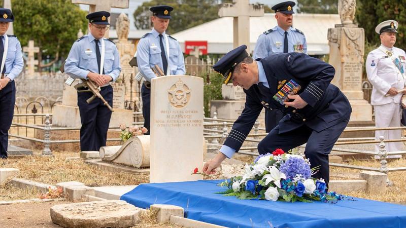 Officer Commanding No. 92 Wing Group Captain John Grime lays a poppy at the grave of Flying Officer Maxwell Pearce in Salisbury, South Australia. Photo: Leading Aircraftman Stewart Gould