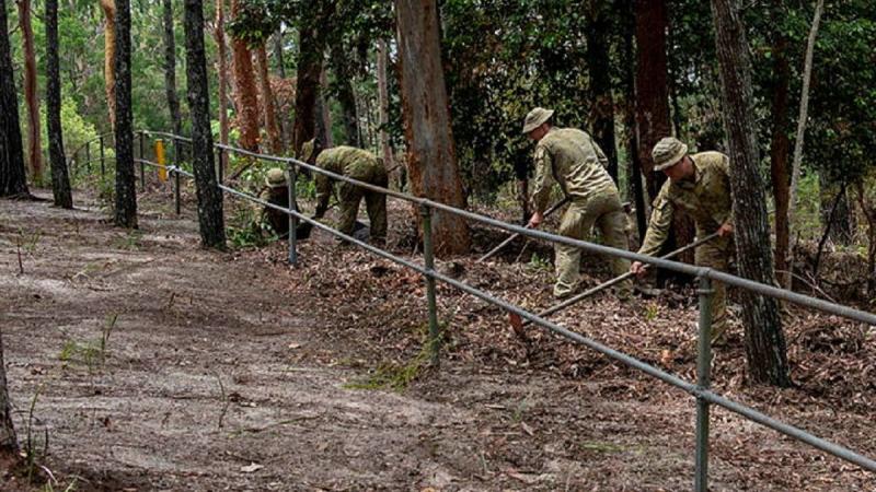 Volunteers from the 1st Signal Regiment clear a path used for cultural awareness activities at Terra Bulla Leumeah on North Stradbroke Island, Queensland. Photo: Sergeant Anita Gill