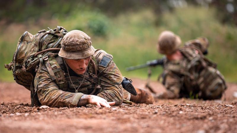 Sapper Brandon Subloo, of the 2nd Combat Engineer Regiment, navigates his section out of a simulated mine explosion serial during the a Military Skills competition at Gallipoli Barracks, Brisbane. Photo: Corporal Nicole Dorrett