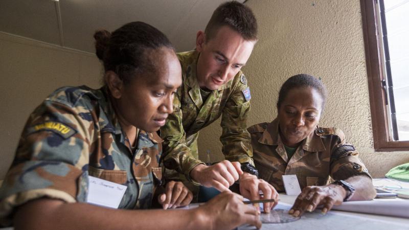 Australian Army Lieutenant Matthew Taylor assists Vanuatu Police Force Corporals Josephine Fred, left, and Kimason Doro with navigation training during the Sergeants Course at Cook Barracks, Port Vila. Photo: Corporal Robert Whitmore