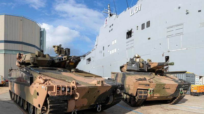 The Hanwha Defense Australia Redback, left, and the Rheinmetall Defence Australia KF-41 Lynx next to HMAS Adelaide at HMAS Kuttabul. Photo: Able Seaman Benjamin Ricketts