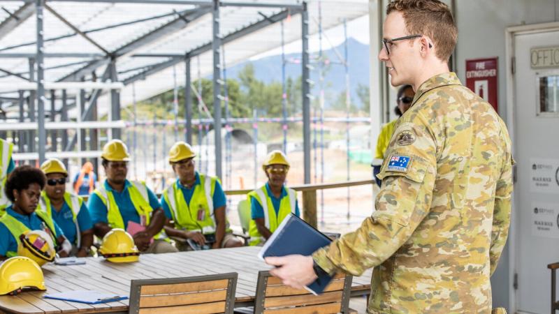Army officer Captain Cameron Laing provides a site brief to Fijian TAFE students at the Blackrock Redevelopment Project in Fiji.