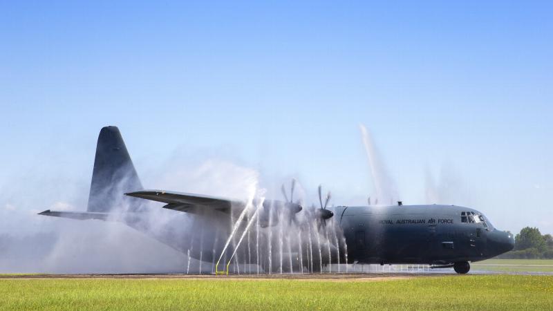 The first No. 37 Squadron C-130J Hercules with Block 8.1 upgrades taxis through the bird bath after returning to RAAF Base Richmond. Photo by Corporal David Said.