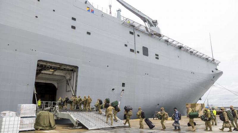 ADF personnel embark onto HMAS Adelaide at the Port of Brisbane before departure on Operation Tonga Assist 2022. Photo: Corporal Robert Whitmore