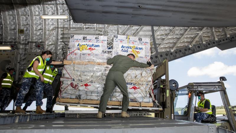 RAAF personnel unload humanitarian assistance and engineering equipment from a C-17A Globemaster III aircraft at Fua’amotu international airport in Tonga. Photo by Leading Aircraftwoman Emma Schwenke. 