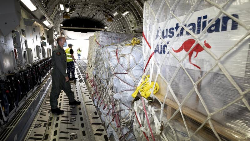 RAAF loadmaster Corporal Dale Hall from No. 36 Squadron inspects the loading of Tonga-bound supplies inside a C-17A Globemaster III at RAAF Base Amberley. Photo by Leading Aircraftwoman Kate Czerny.