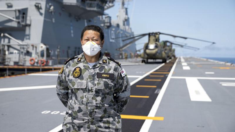 Tongan-born Royal Australia Navy officer Chaplain Simote Finau on the flight deck of HMAS Adelaide during Operation Tonga Assist 2022. Photo: Corporal Robet Whitmore.