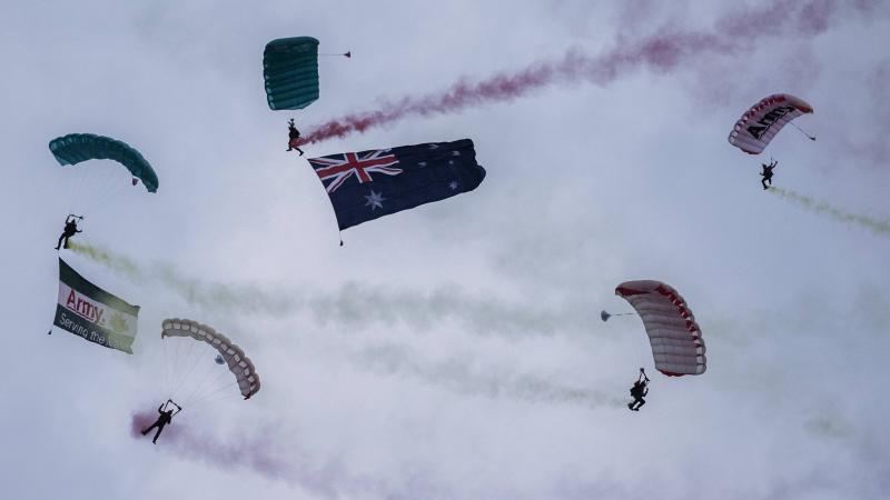 Australian Army soldiers from the ADF Parachuting School's Red Berets parachute display team drop into Sydney's Australia Day festivities. Photo: Corporal Sagi Biderman.