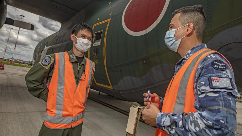 Air Force linguist Leading Aircraftman Alexander Andrews (right) talks to Japan Air Self-Defense Force officer Captain Otsuka Masato at RAAF Base Amberley. Photo: Corporal Jesse Kane.