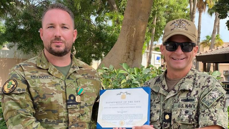 Lieutenant Justin Mellross, left, receives the United States Navy and Marine Corps Achievement Medal from Commanding Officer USS Firebolt Lieutenant Commander Raymond Miller IV. Photo: Lieutenant E Garcia, United States Navy