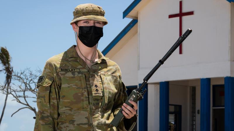 Lieutenant Lauren Barclay outside the Wesleyan church on Atata Island, Tonga. Photo: Leading Seaman David Cox