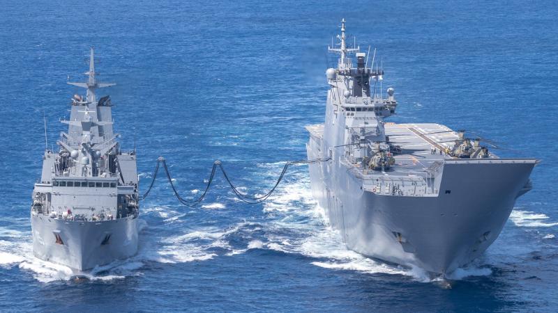 HMAS Supply (left) and HMAS Adelaide conduct a replenishment at sea during Operation Tonga Assist 2022. Photo: Corporal Robert Whitmore.