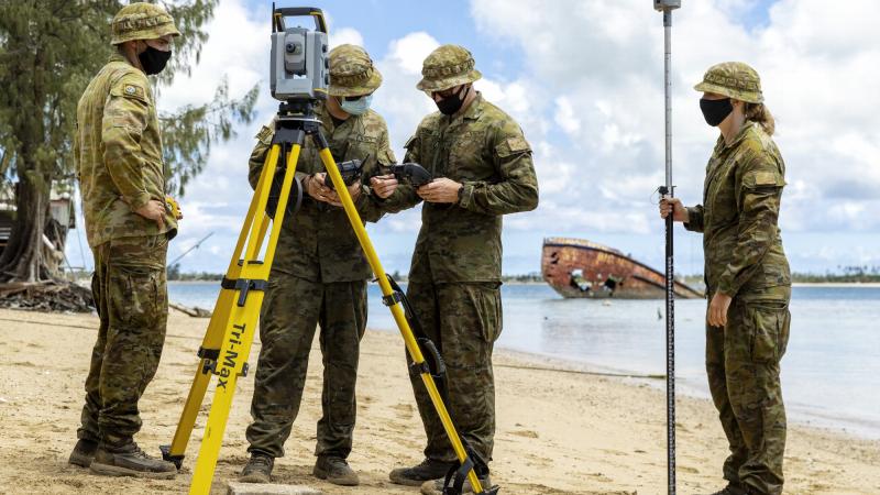 A Navy deployable geospatial support team from HMAS Adelaide surveys the beach on Pangaimotu Island in Tonga. Photo: Petty Officer Jake Badior