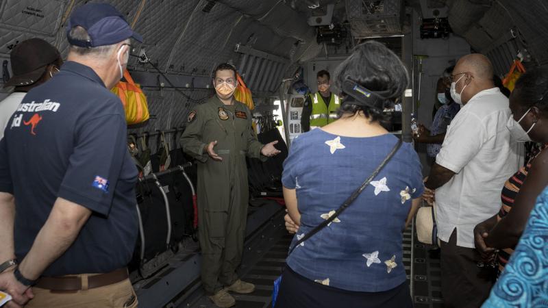 RAAF pilot Squadron Leader Justin Della Bosca gives Solomon Islands Government officials a tour inside a C-27J Spartan aircraft at Honiara international airport, Solomon Islands. Photo: Corporal Jarrod McAneney.