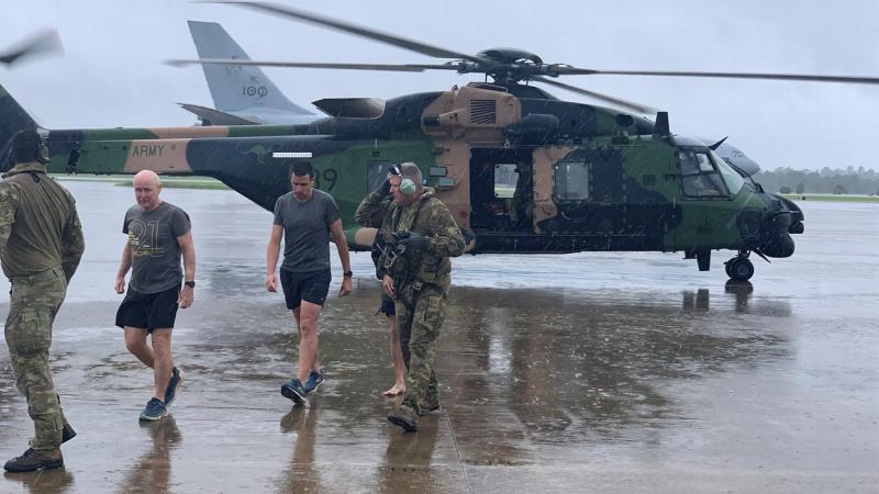 Army soldiers from the School of Army Aviation arrive safely at RAAF Base Amberley after rescuing several south-east Queensland community members affected by the rising flood waters.