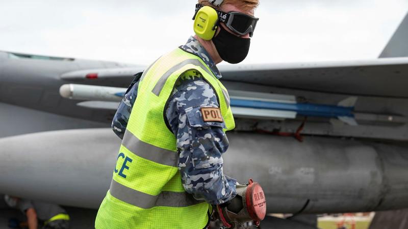 Leading Aircraftman Ronan Geoghgan, from No. 23 Squadron, retrieves a hose after refuelling a Japan Air Self-Defense Force F-15J Eagle aircraft at Andersen Air Force Base, Guam, during Exercise Cope North 2022. Photo: Leading Aircraftman Sam Price