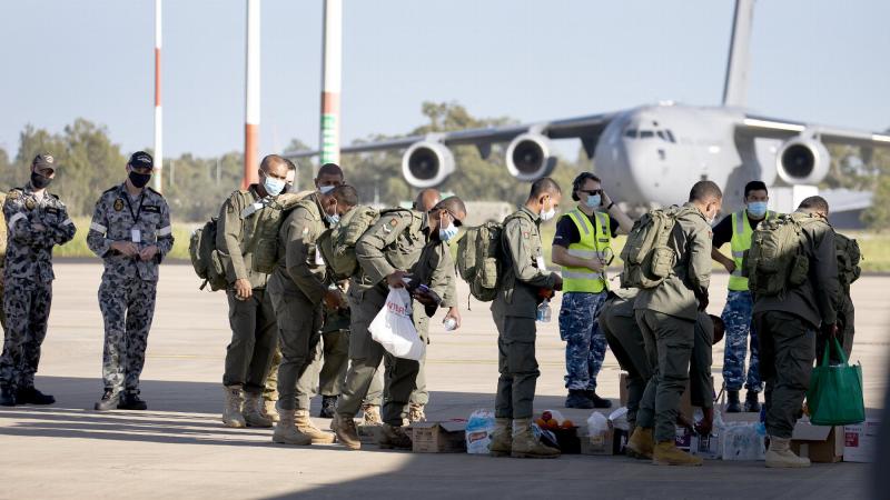 Royal Australian Air Force air movements personnel assist Republic of Fiji Military Forces engineers and medical personnel bound for Tonga to a C-130J Hercules aircraft at RAAF Base Amberley in Queensland. Photo: Leading Aircraftwoman Kate Czerny