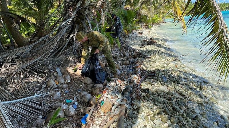 HMAS Glenelg personnel clean-up a beach on Direction Island, which is part of the Cocos (Keeling) Islands group, during their recent Operation Resolute deployment. Photo: Sub Lieutenant Luke Bennet