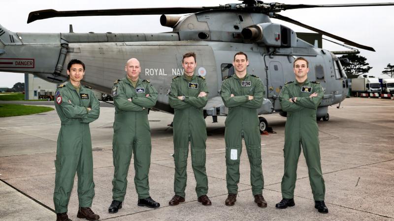Royal Australian Navy pilot Lieutenant Dan Cochrane, left, and the Royal Navy Merlin Mark 2 helicopter crew that rescued a kayaker off Cornwall in southern England.  Photo: Royal Navy
