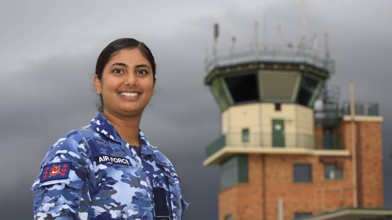 Royal Australian Air Force air traffic controller Pilot Officer Gulman Madahar, of No. 452 Squadron, in front of the RAAF Base Amberley air traffic control tower in Queensland. Photo: Corporal Brett Sherriff