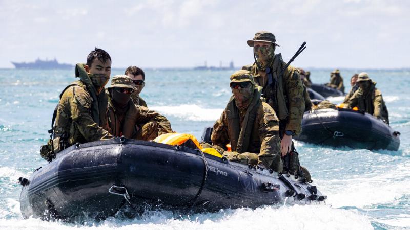 Soldiers from 2RAR's small boat platoon move 2nd Combat Engineer Regiment personnel onto Atata Island in Tonga. Photo: Petty Officer Jake Badior