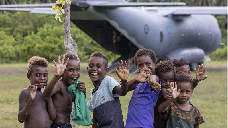 Solomon Islands children welcome an Air Force C-27J Spartan aircraft carrying food and critical aid supplies to Auki airport, Solomon Islands. Photo: Corporal Jarrad McAneney