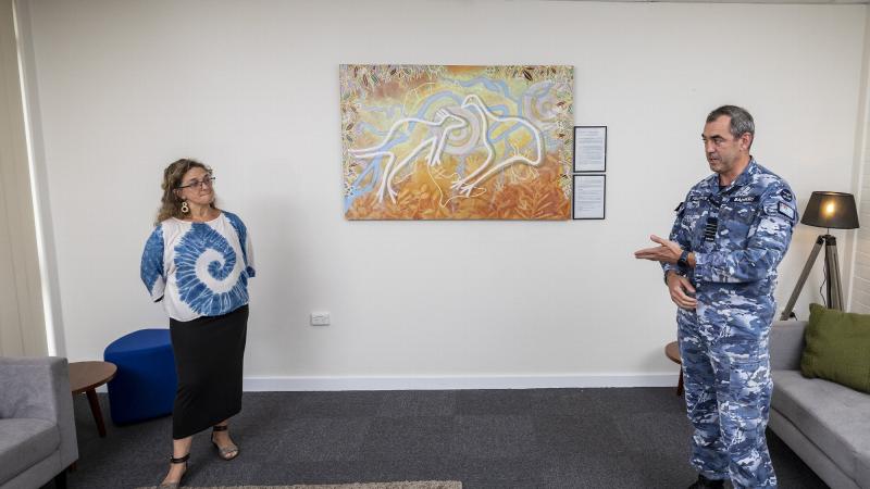 Group Captain James Badgery thanks artist Leanne Tobin, of the Buruberongal and Wumali clans of the Dharug, for her artwork that will hang in the Mirrung Room at the Air Lift Systems Program Office, RAAF Base Richmond. Photo: Corporal Dan Pinhorn
