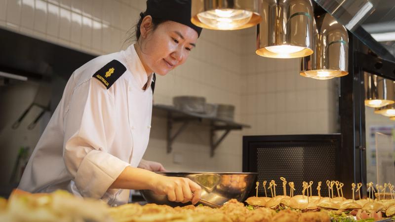 Able Seaman Su Lee prepares lunch in the HMAS Kuttabul officers’ galley in Sydney. Photo: Corporal Jacob Joseph