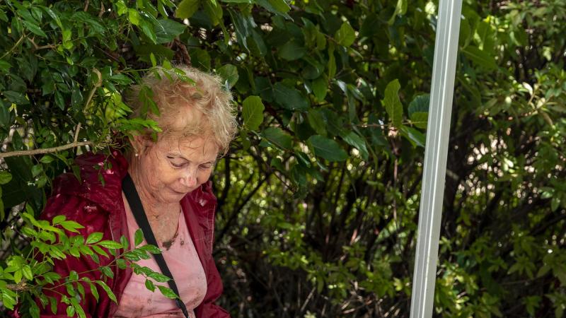 Army Corporal Sebastian Evens (right) from 6th Battalion, Royal Australian Regiment, applies a bandage to St Lucia resident Ms Ann Mckenzie. Photo: Corporal Nicole Dorrett