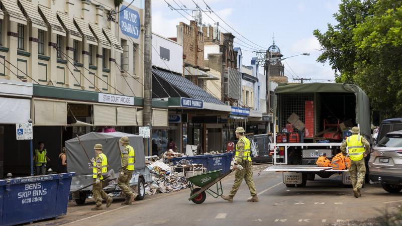 Army soldiers from the 5th Engineer Regiment assist the local community of Lismore in moving water-damaged belongings during Operation Flood Assist 2022. Photo: Corporal Dustin Anderson