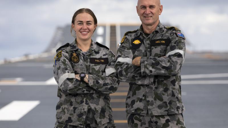 Army soldier Private Tim Melvin, right, reunites with his daughter, Navy sailor Leading Seaman Esther Melvin, on HMAS Canberra on Operation Tonga Assist 2022. Photo: Leading Seaman Daniel Goodman