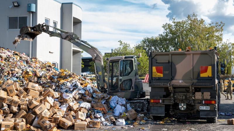 A soldier from 2nd/14th Light Horse Regiment (Queensland Mounted Infantry) removes flood-damaged produce from a cold storage warehouse at the Brisbane Markets in Rocklea. Photo: Cpl Nicole Dorrett