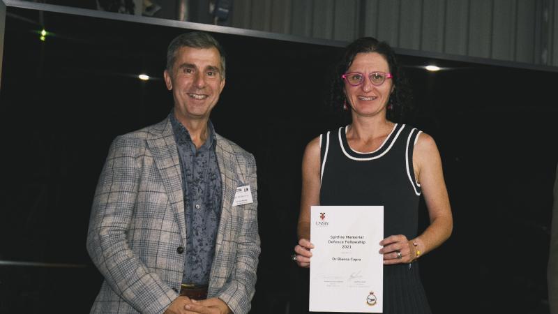 Air Commander Australia Air Vice-Marshal Joe Iervasi presents a certificate to Dr Bianca Capra as the Spitfire Memorial Defence Fellowship 2021 recipient during the 60th anniversary of the Spitfire Association. Photo: Sergeant Oliver Carter