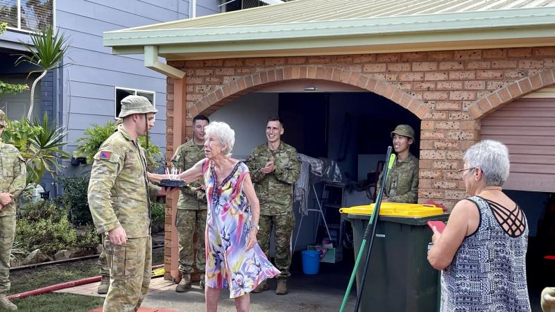 Soldiers from 1st Regiment, Royal Australian Artillery, assisted Bribie Island resident Beverly with clean-up around her home as part of Operation Flood Assist 2022 before helping celebrate her 91st birthday.