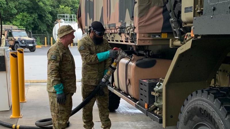 Private Tejinder Singh (right) and Private Leon Hooke of 9th Force Support Battalion prepare an Army truck for travel to Lismore in northern NSW to assist with clean-up efforts. 
