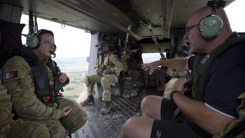 Major-General David Thomae and Mayor of Lismore Steve Krieg survey the damage and recovery efforts in Lismore from an Army MRH-90 Taipan. Photo: Warrant Officer Class 2 Max Bree