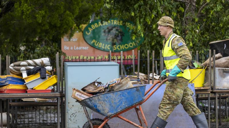An Army soldier from 5th Engineer Regiment assists with clean up at Cabbage Tree Island Primary School in northern NSW as part of Operation Flood Assist 2022. Photo: Corporal Dustin Anderson
