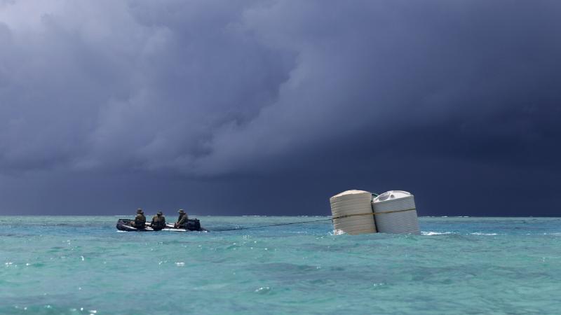 Australian Army soldiers from 2nd Battalion, Royal Australian Regiment, deliver water tanks via Zodiac inflatable boat to Kotu Island, Tonga, as part of Operation Tonga Assist 2022. Photo: Able Seaman Susan Mossop