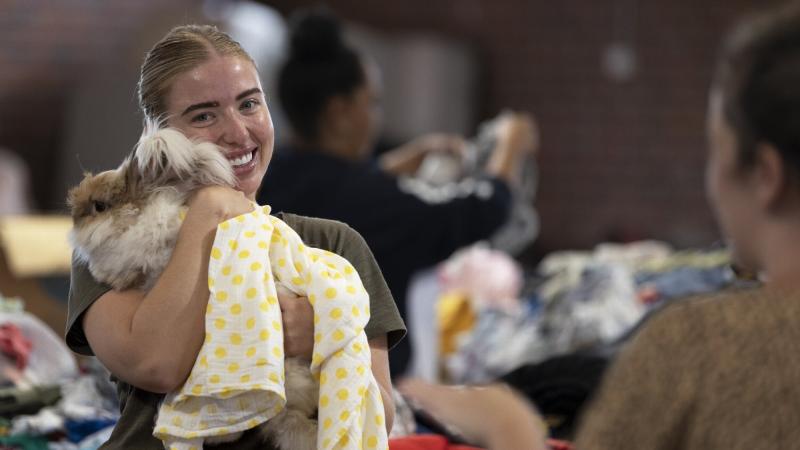 Corporal Rebecca Barry embraces a Casino local while organising donations at the local racecourse and showgrounds in northern NSW as part of Operation Flood Assist 2022. Photo: Corporal Sagi Biderman