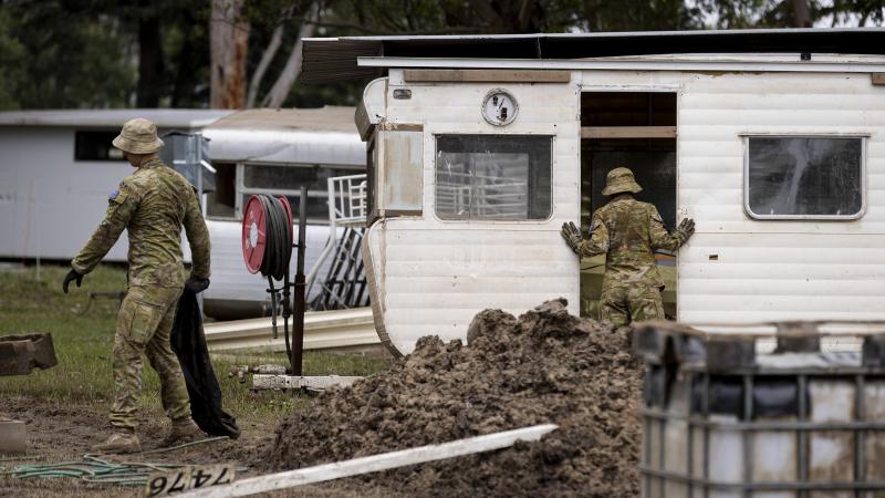 Australian Army soldiers assess and clear debris from Sackville Ski Gardens caravan park in Sydney as part of Operation Flood Assist 2022. Photo: Corporal Julia Whitwell